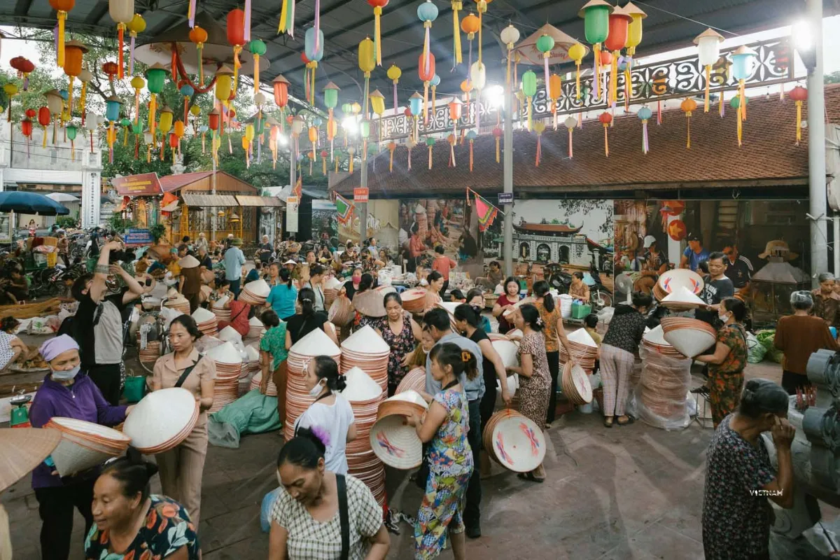 Exclusive Hanoi to Ninh Binh Day Tour: Incense Village & Trang An Boat Chuong village hat market selling traditional conical hats