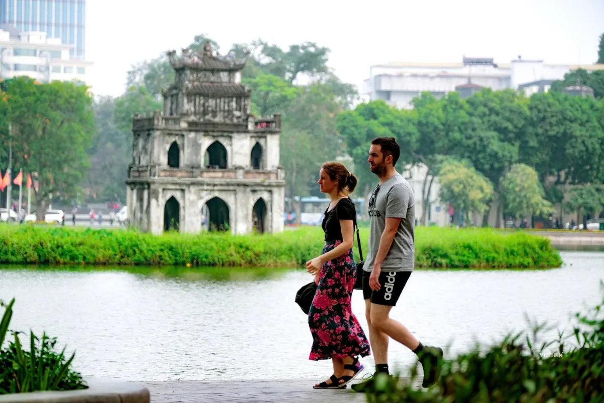 Hanoi city walking tour through bustling Old Quarter streets and Hoan Kiem lake