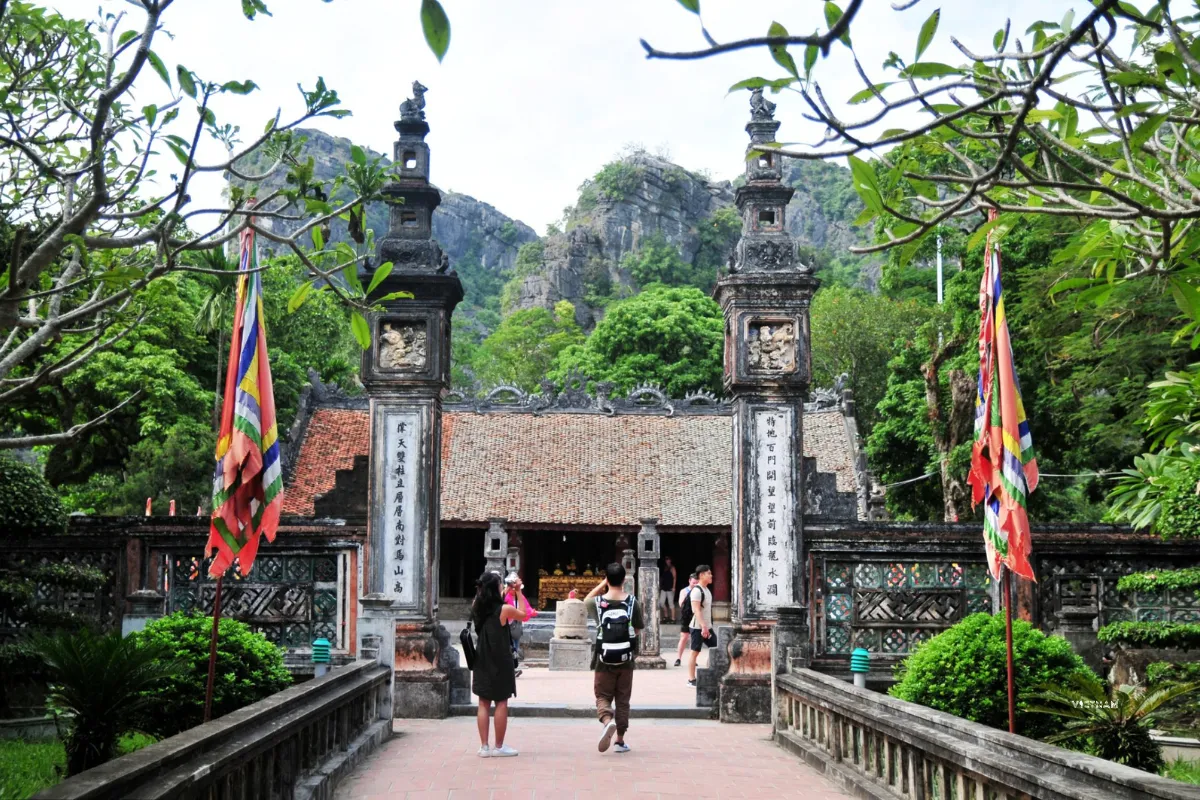 Tam Coc Private Tour | Hoa Lu Ancient Capital | Cycling to Bich Dong Hoa Lu ancient capital entrance gate with mountains