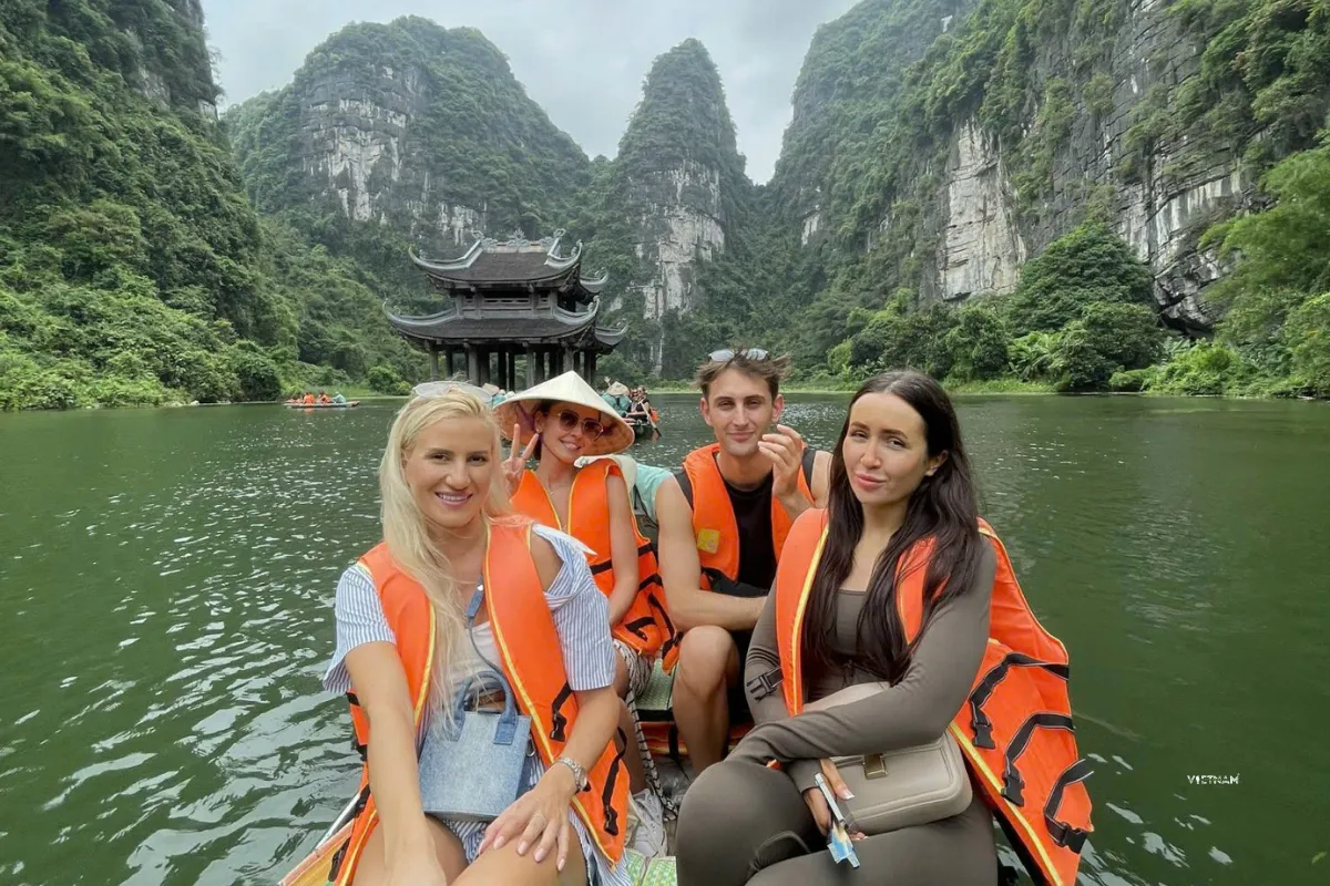 Trang An boat tour through limestone mountains in Trang An complex