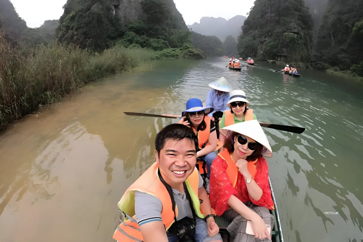 Trang An tour boat ride through limestone mountains and river