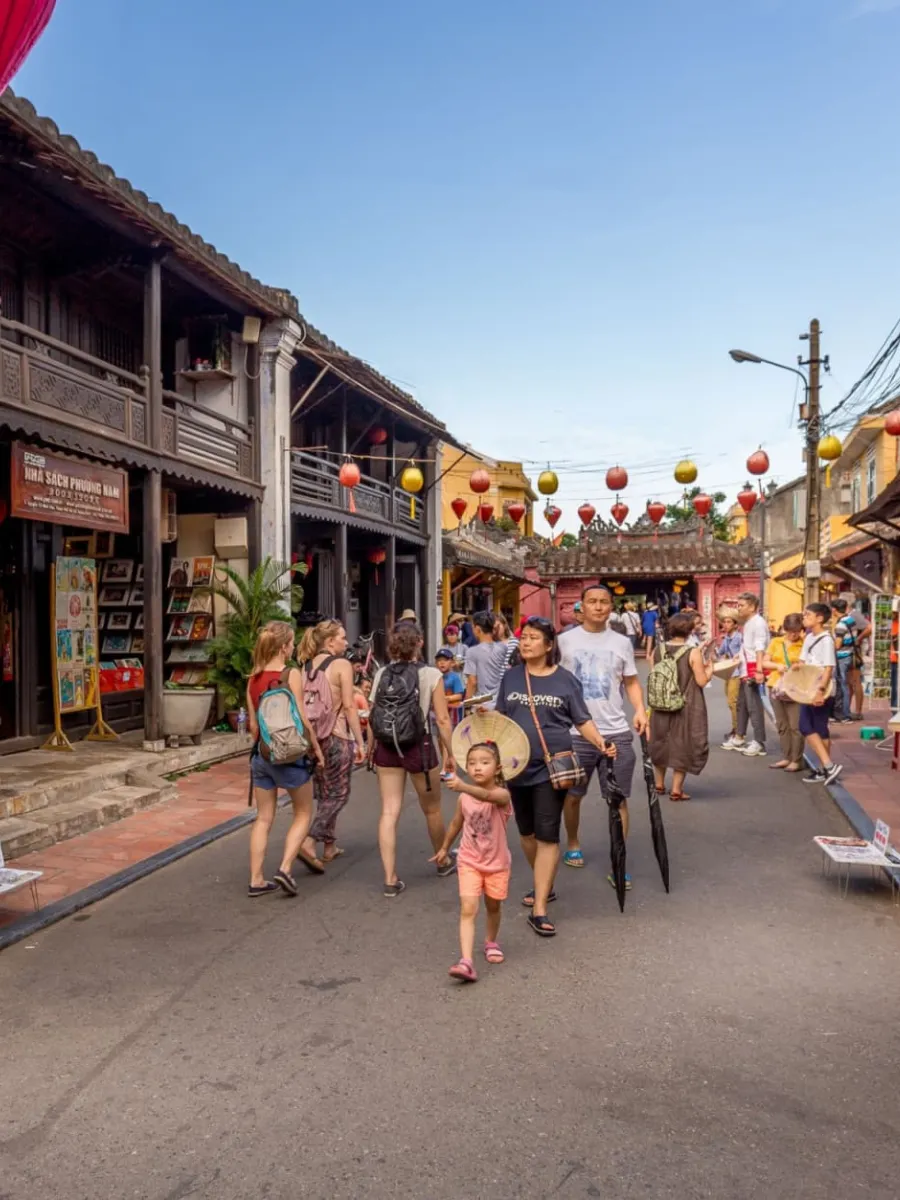 ravelers exploring old streets and lanterns in Hoi An Ancient Town near Da Nang Vietnam